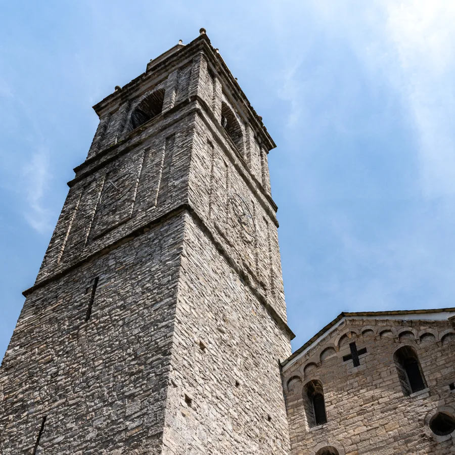 Close-up view of the bell tower of San Giacomo Church in Bellagio against a blue sky