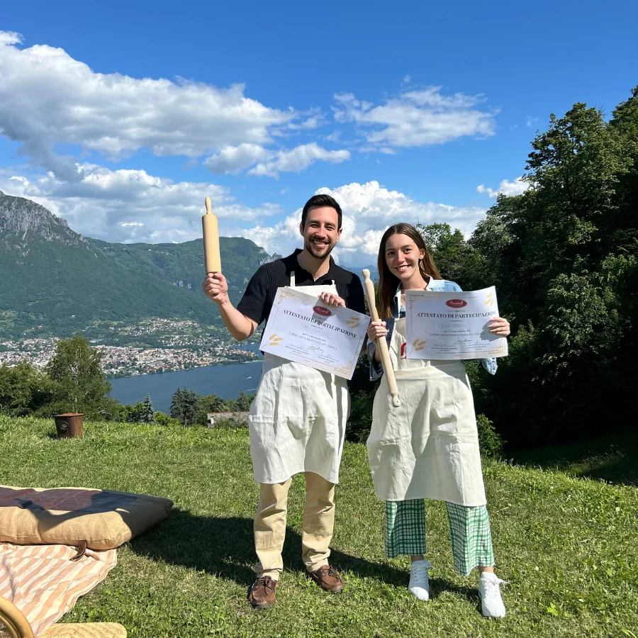 Smiling participants proudly displaying the certificates they earned after learning to make fresh pasta
