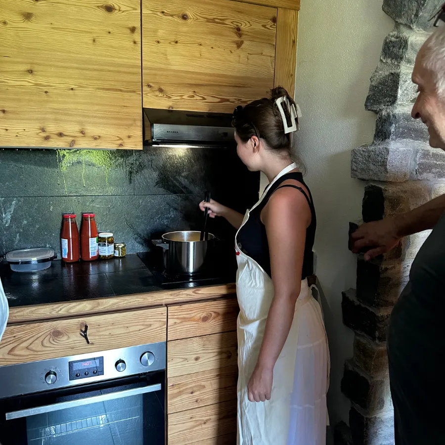 Woman in apron cooking a traditional Italian recipe in a cozy rustic kitchen on Lake Como