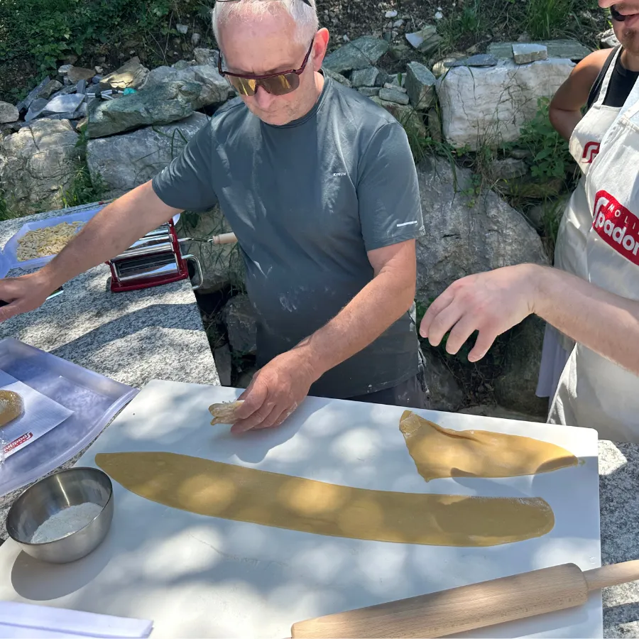 Handmade fresh pasta being prepared during an outdoor culinary workshop on Lake Como