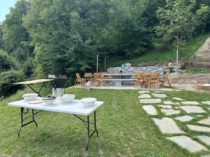 Fully equipped outdoor kitchen with granite counters, sink, and workspaces at Baita TreeB in Bellagio